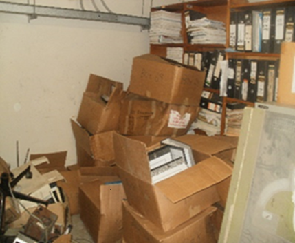 Unprocessed records stored in cartons and inaccessible