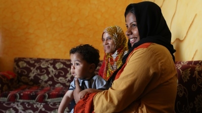 Faten Ahmed holds her 1-year-old son, Ahmed while listening to some advice from a maternity health worker. World Bank supports Abu Bakr Society for Community Development in Tod, Upper Egypt as part of Labor Intensive Public Works Project. Luxor, Egypt.