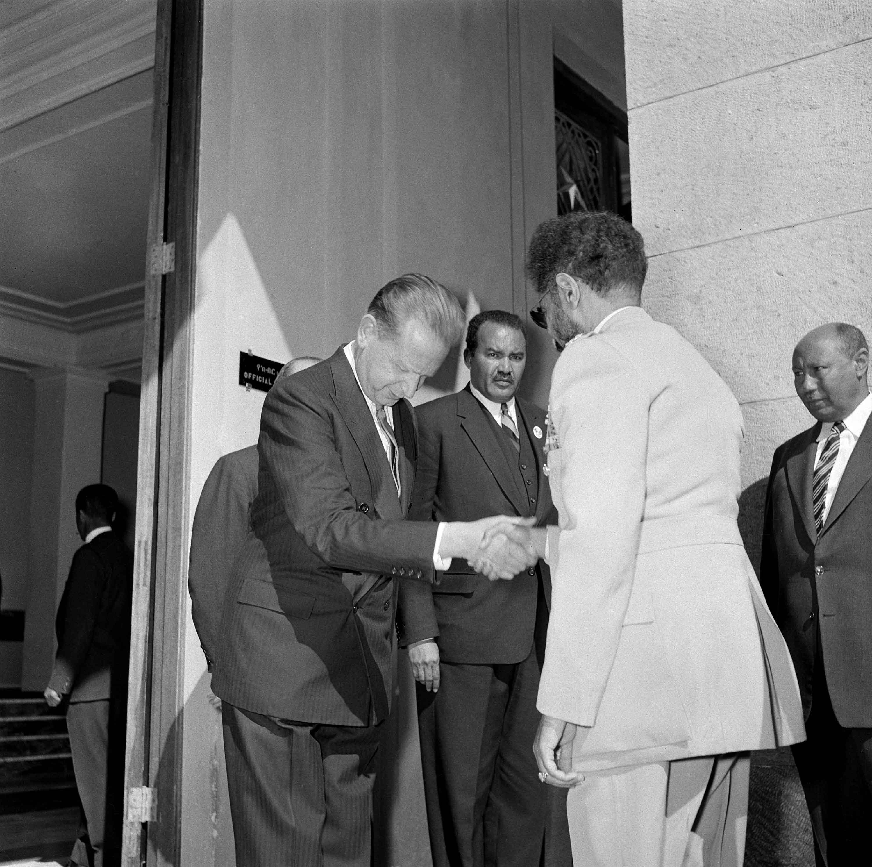 Secretary-General of the United Nations, Dag Hammarskjöld, greeting Emperor Haile Selassie I in Addis Ababa, 29 December 1958, ahead of the inaugural session of the Economic Commission for Africa. At centre back is the first ECA Executive Secretary, Mekki Abbas.