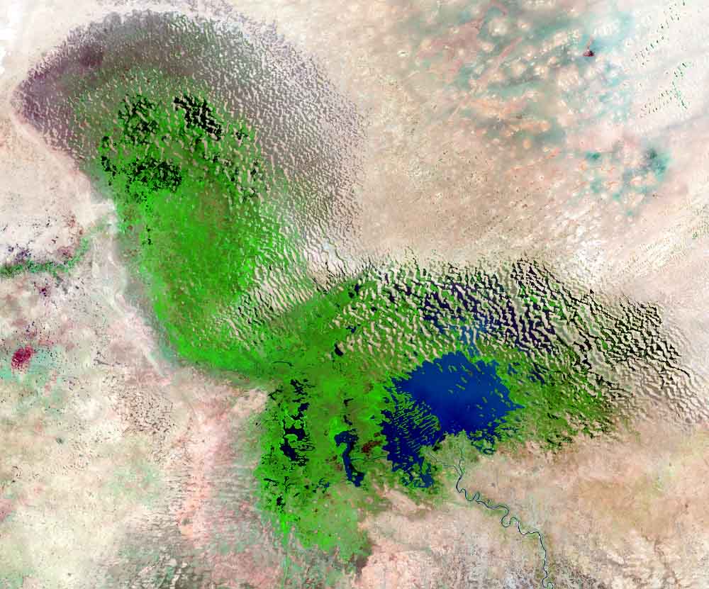 The Landsat image was taken in June 2018, which shows a shrinking lake Chad in West Africa. The African Centre of Meteorological Applications for Development contributes to the strengthening of Africa’s resilience to extreme weather events by improving the understanding of atmospheric and climatic processes throughout the continent. Photo © EARTHSHOTS