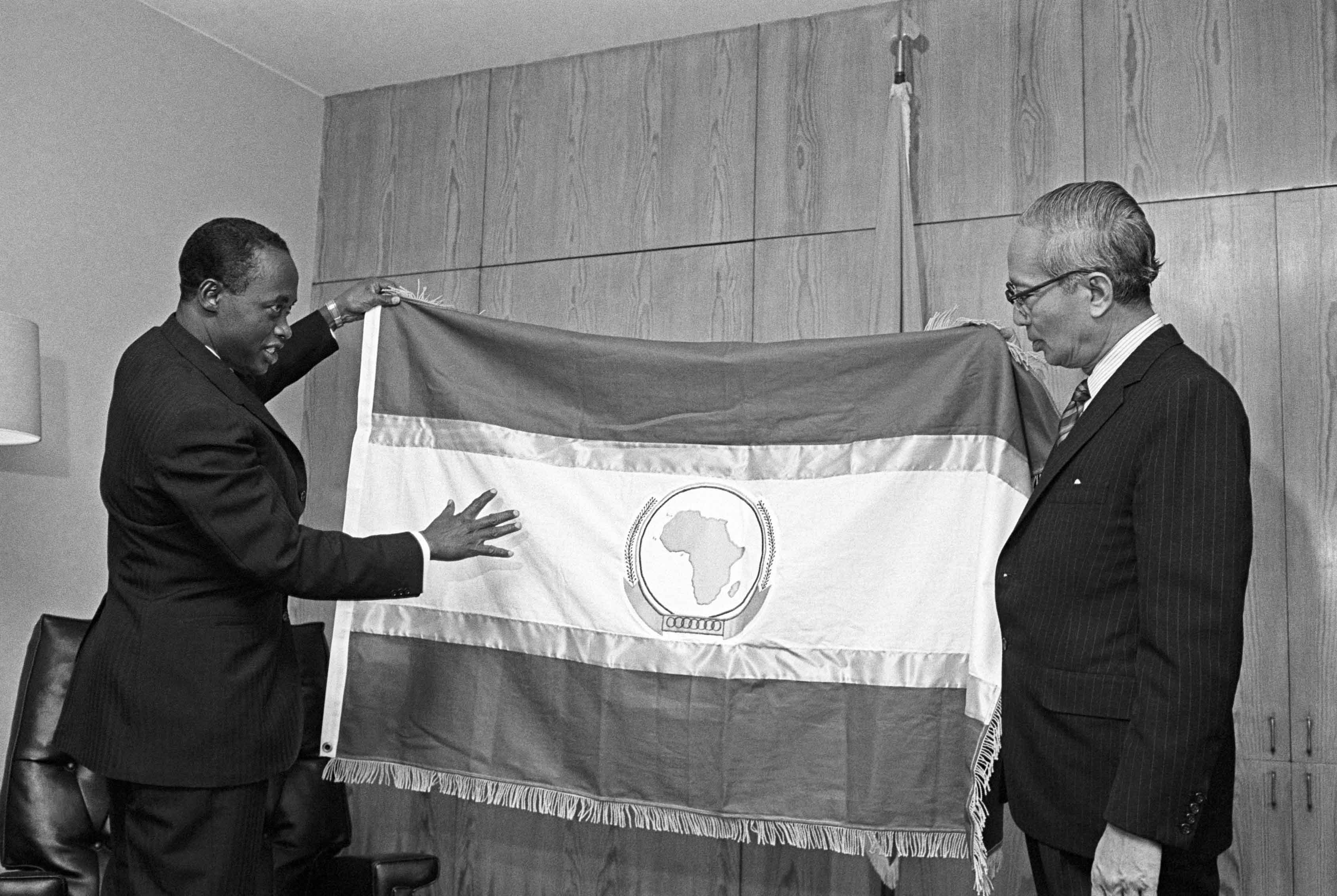 ENHANCING THE ROLE OF UNITED NATIONS IN AFRICA: Secretary- General of the Organization for African Unity (OAU), Diallo Telli (Guinea), presented the Secretary-General, U Thant, with the flag of the Organization. ECA plays a role in consensus building, which extends to the formulation of common positions on important global issues and thus to moulding Africa’s “voice” on such issues.