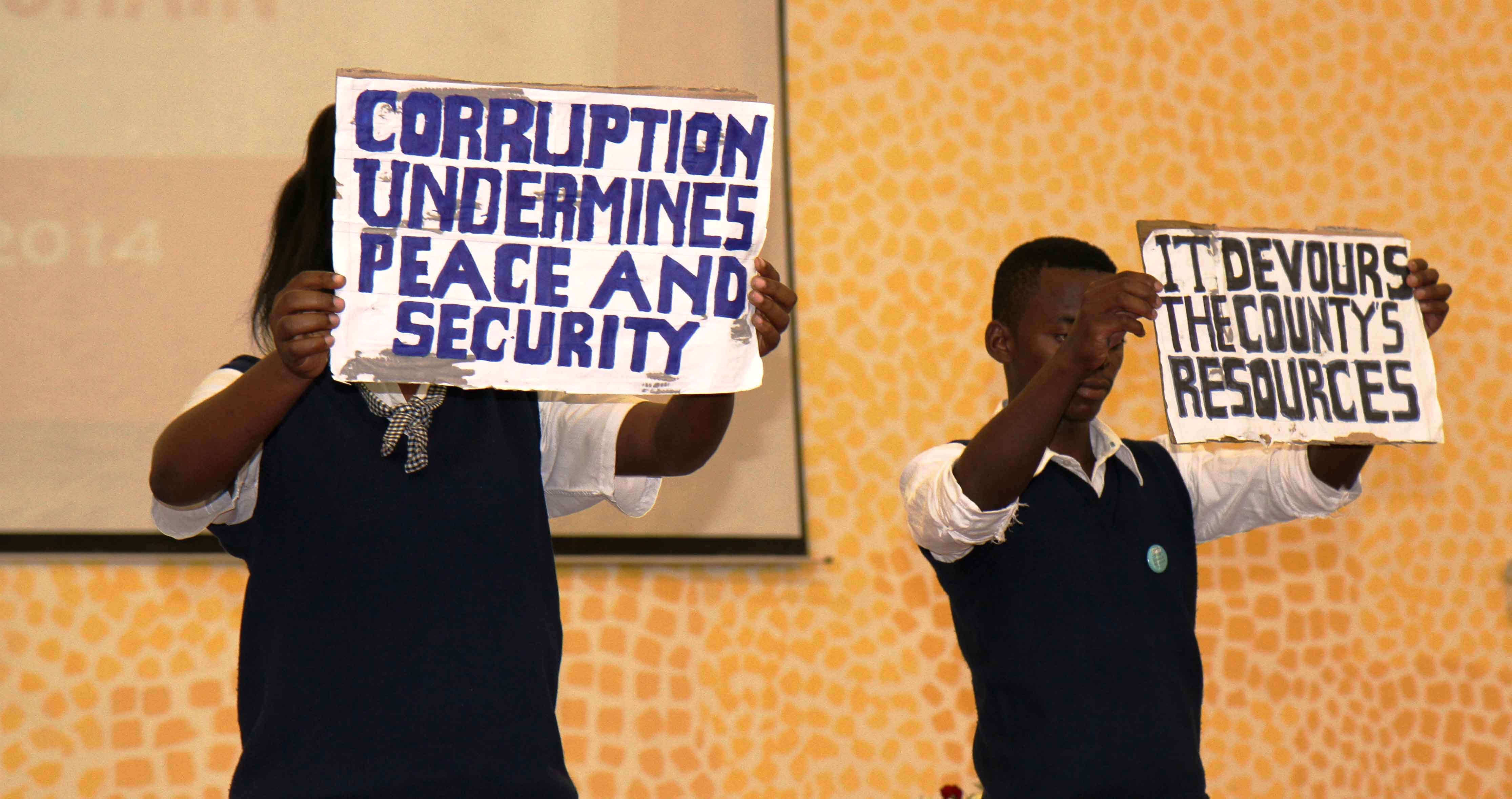 Pupils from Munali Girls and Boys Secondary Schools Anti–Corruption Clubs raising awareness through a poem on the danger of corruption. Photo: Moses Zangar, Jr./UNDP in Zambia