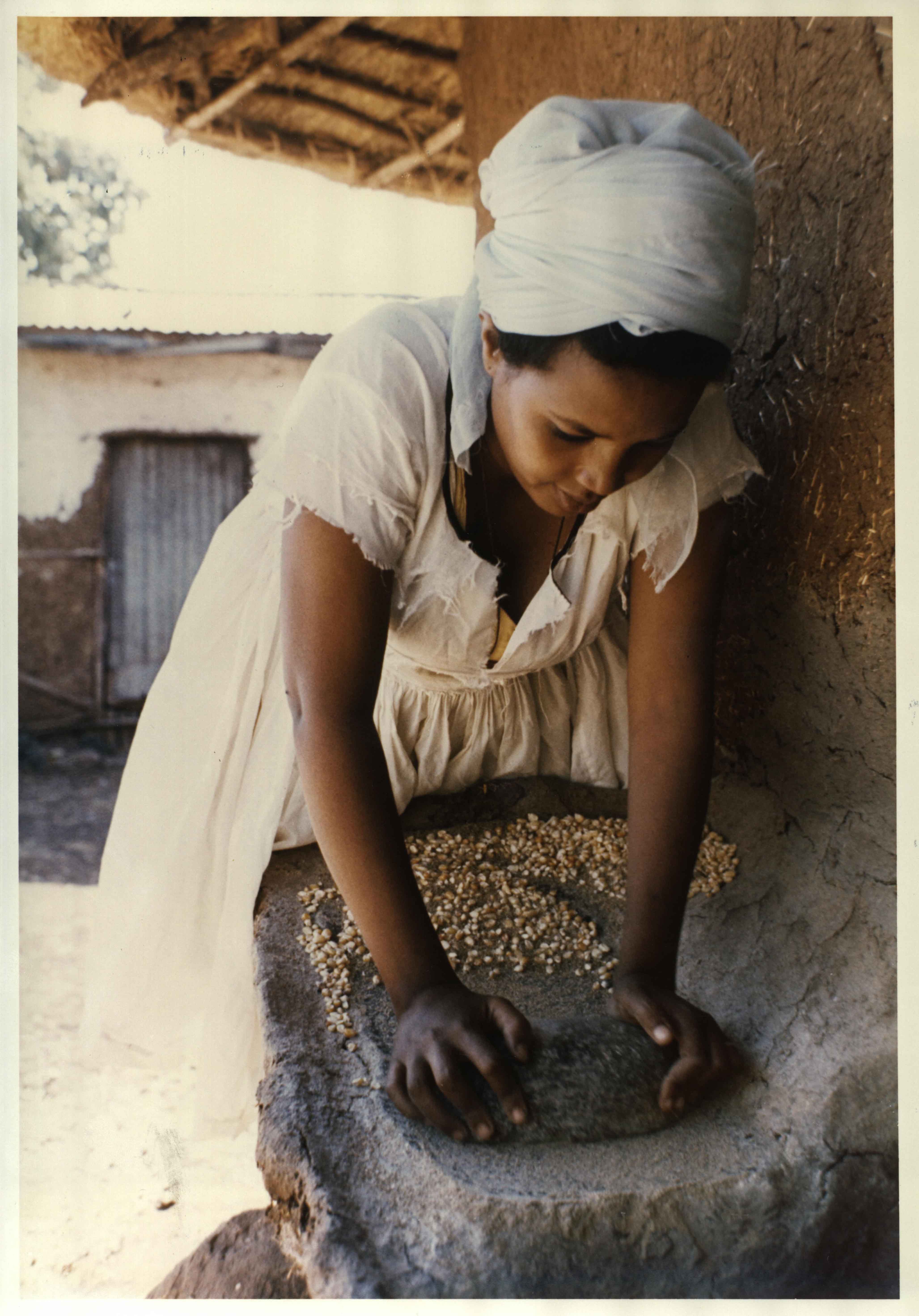 HUMAN RESOURCE DEVELOPMENT: In the rural village of Godino, a woman grinding grain to make a meal. In an effort to help rural women in Africa to improve their living conditions, ECA appointed experts on rural development, to the Pan African Women’s Centre in Addis Ababa, 1976. HUMAN RESOURCE DEVELOPMENT: In the rural village of Godino, a woman grinding grain to make a meal. In an effort to help rural women in Africa to improve their living conditions, ECA appointed experts on rural development, to the Pan African Women’s Centre in Addis Ababa, 1976.
